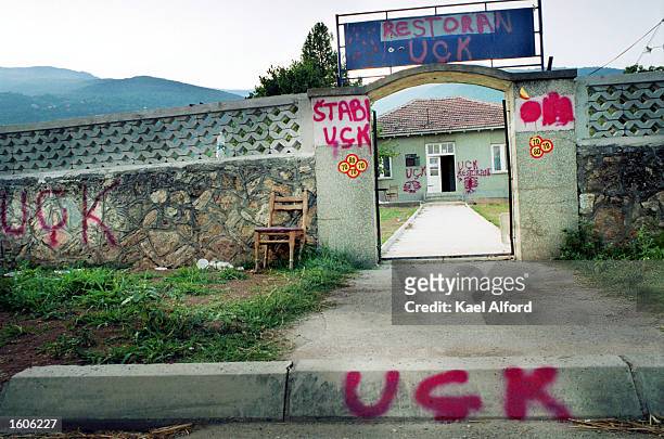 Graffitti left by members of the Albanian Rebel group the National Liberation Army marks a roadside business August 1, 2001 in Leshok, Macedonia,...