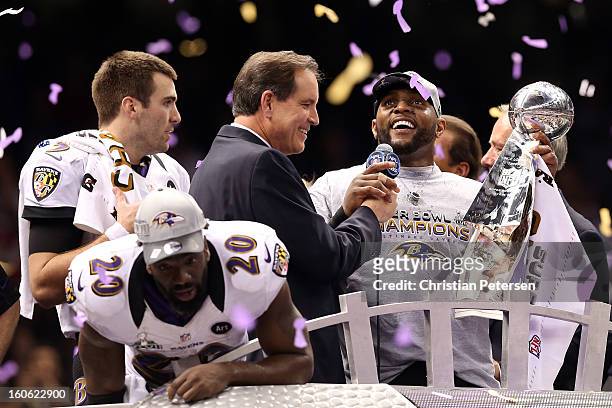 Joe Flacco, Ed Reed and Ray Lewis of the Baltimore Ravens celebrate with the VInce Lombardi trophy after the Ravens won 34-31 against the San...