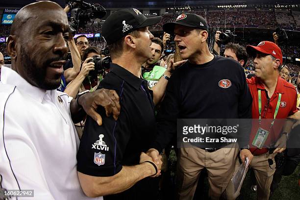 Head coach John Harbaugh of the Baltimore Ravens shakes hands with his brother head coach Jim Harbaugh of the San Francisco 49ers after winning Super...
