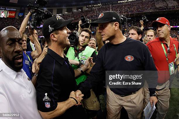 Head coach John Harbaugh of the Baltimore Ravens shakes hands with his brother head coach Jim Harbaugh of the San Francisco 49ers after winning Super...