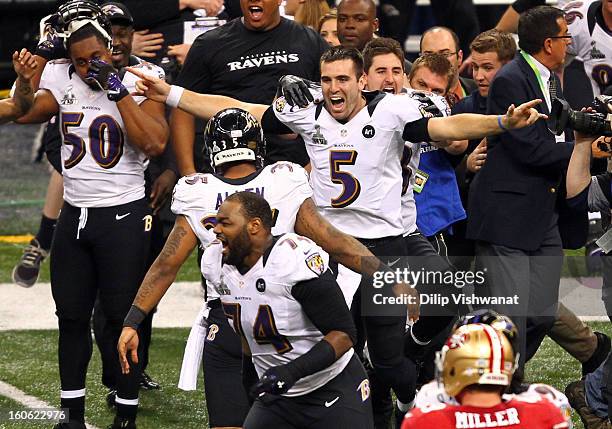 Joe Flacco of the Baltimore Ravens celebreates with his teammates after defeating the San Francisco 49ers during Super Bowl XLVII at the...