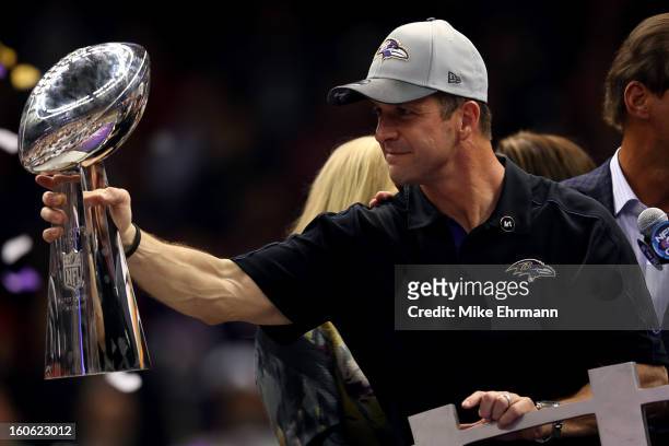 Head coach John Harbaugh of the Baltimore Ravens holds up the Vince Lombardi Trophy following their 34-31 win against the San Francisco 49ers during...