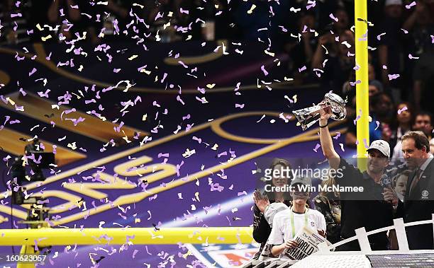 Head coach John Harbaugh of the Baltimore Ravens celebrates with the Vince Lombardi trophy next to his wife Ingrid and his daughter Alison after the...