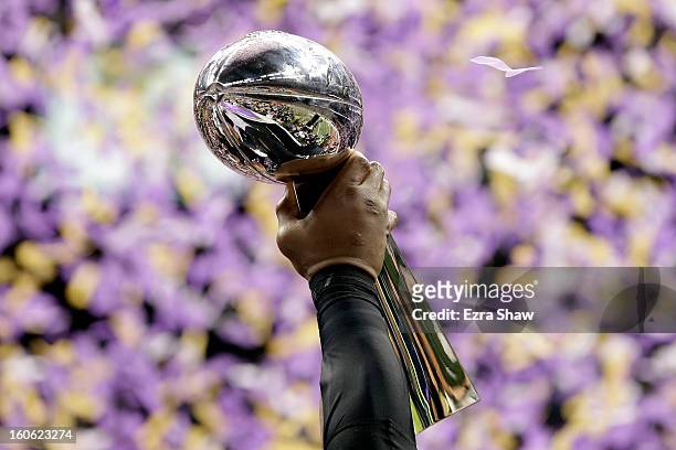 Ray Lewis of the Baltimore Ravens holds up the Vince Lombardi Trophy after defeating the San Francisco 49ers during Super Bowl XLVII at the...