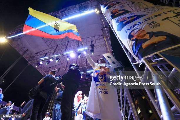 Supporter of presidential candidate Christian Zurita, waves an Ecuadoran flag during a campaign closing rally on August 17, 2023 in Quito, Ecuador....
