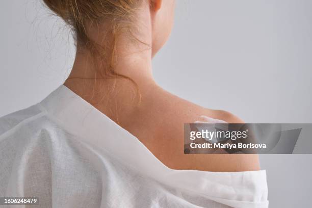 a smear of white cream on a woman's shoulder. - human skin texture stock pictures, royalty-free photos & images
