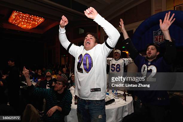 Baltimore Ravens fans cheer as they gather to watch Super Bowl XLVII against the San Francisco 49ers during the official NFL China Super Bowl Party...