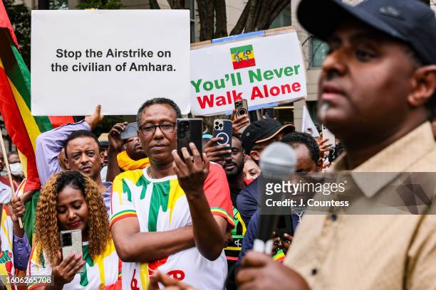 Journalist Habtamu Ayalew Teshome speaks to the crowd as members of the Washington DC Ethiopian community demonstrate outside of the U.S. State...