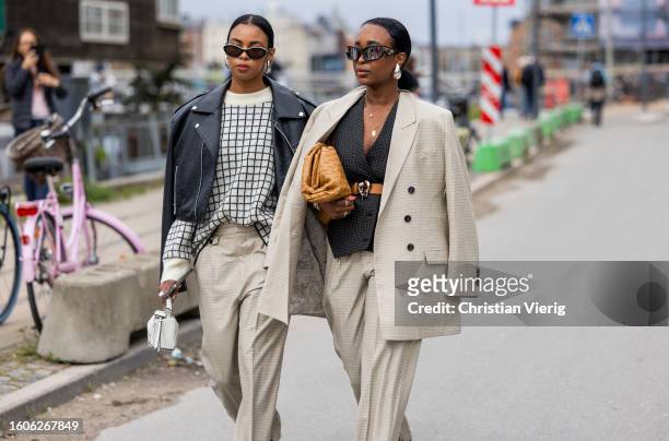 Guests wearing beige suit, black leather jacket outside Munthe during the Copenhagen Fashion Week Spring/Summer 2024 on August 10, 2023 in...