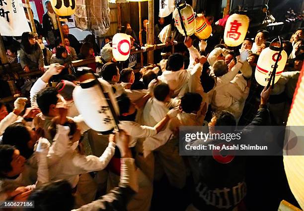 Men wearing white clothes holding lanterns mod each other during the Yaaya Festival on February 2, 2013 in Owase, Mie, Japan. The festival lasts...