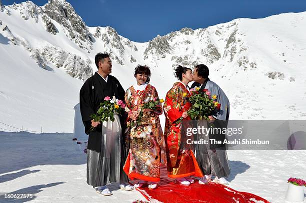 Couples attend the 'Pure White Wedding' hosted by Komagane City at Senjojiki Kar on February 3, 2013 in Komagane, Nagano, Japan. The snow field is...