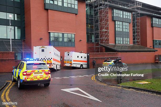 Armed police stand guard as Dale Cregan arrives in an armed convoy to face charges of murder and attempted murder at Preston Crown Court on February...