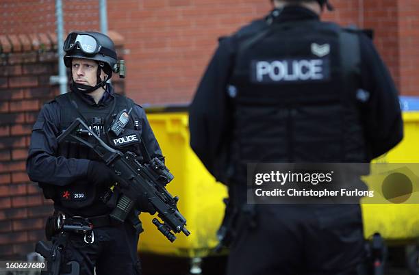 Armed police stand guard as Dale Cregan arrives in an armed convoy to face charges of murder and attempted murder at Preston Crown Court on February...