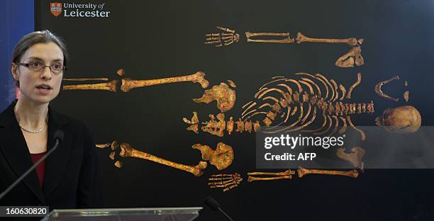 Dr Jo Appleby, a lecturer in bioarchaeology at Leicester University, addresses a press conference in front of an image of the skeleton of Britain's...