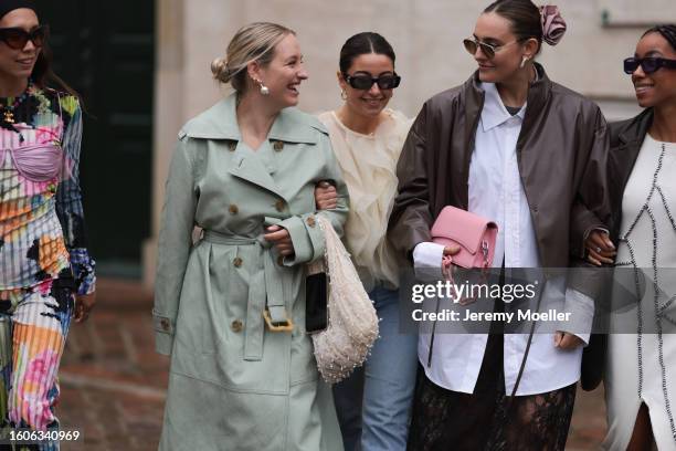 Nicole Huisman seen wearing brown Ganni sunnies, gold hoop earrings, colorful pearl necklace, small rose colored Prada Cleo handbag, colorful printed...