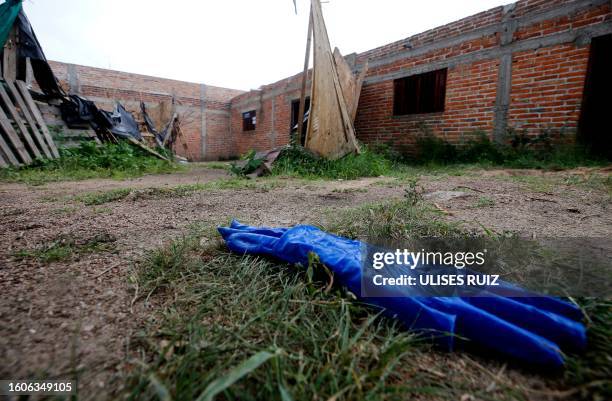 Gloves are seen in the house where allegedly five young men were murdered in Lagos de Moreno, Jalisco State, Mexico, on August 17, 2023. Mexican...