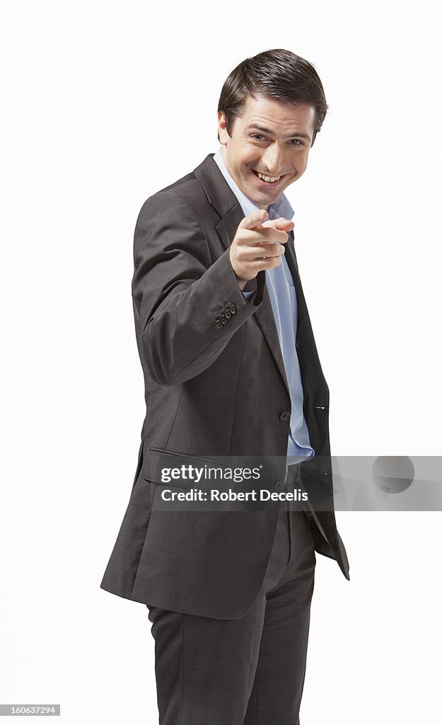 Laughing business man pointing at camera