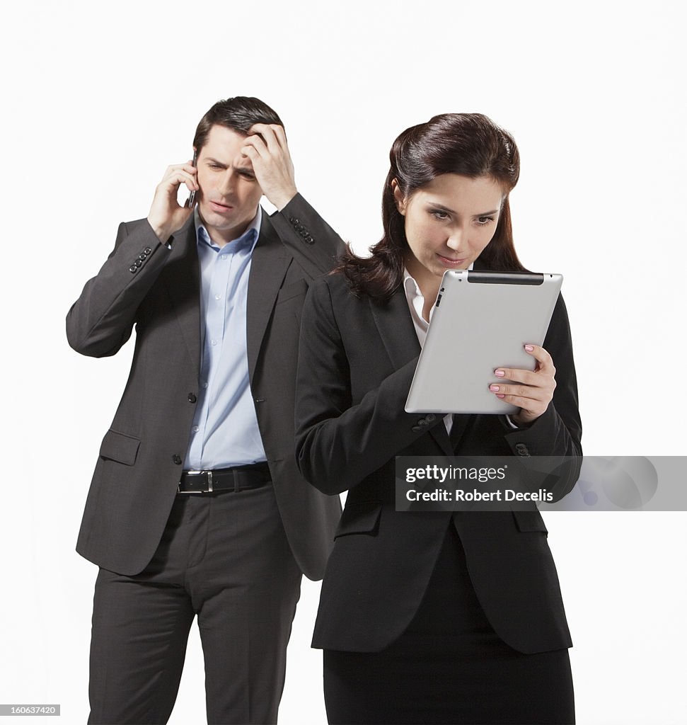 Woman using tablet  colleague in background