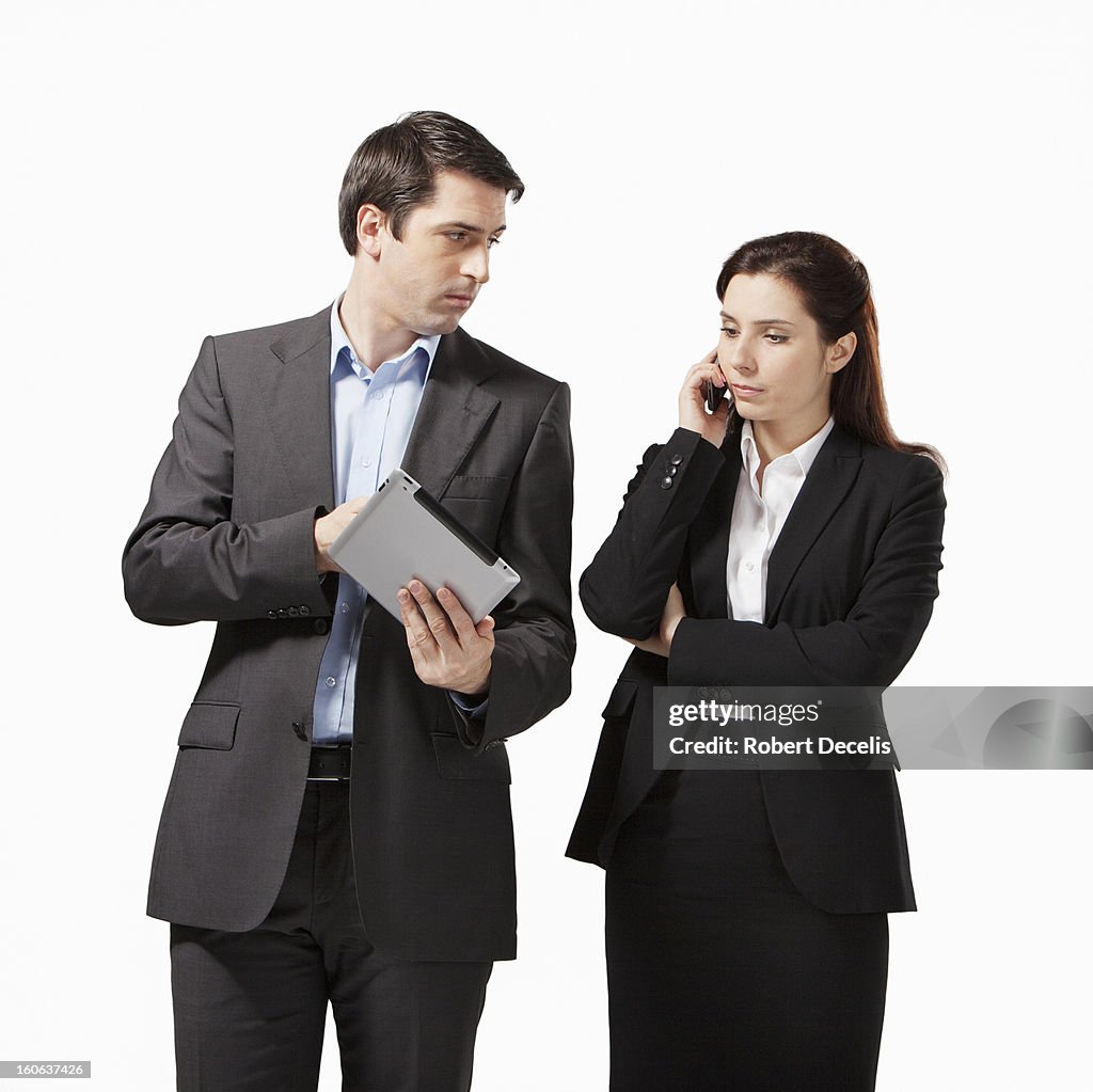 Business man and woman looking at tablet