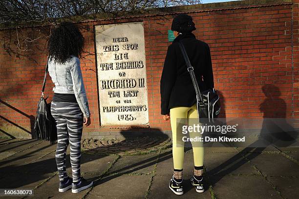 Students read a stone plaque incorrectly claiming to mark the spot where the remains of King Richard III lie near Leicester Catherdral, on February...
