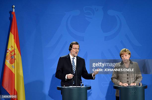 German Chancellor Angela Merkel and Spain's Prime Minister Mariano Rajoy address a press conference at the Chancellery in Berlin on February 4, 2013...