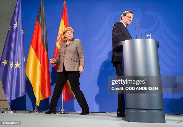 German Chancellor Angela Merkel gets ready to pose with Spain's Prime Minister Mariano Rajoy after their press conference at the Chancellery in...