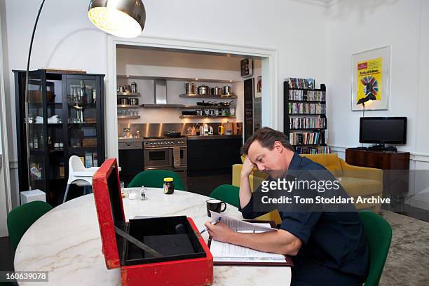 British Prime Minister David Cameron at work on his ministerial red box in the apartment above 11 Downing Street, London, where he lives with his...