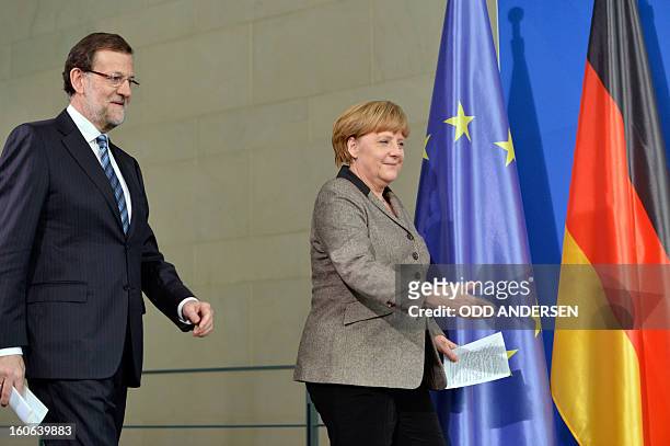 German Chancellor Angela Merkel and Spain's Prime Minister Mariano Rajoy arrive to address a press conference at the Chancellery in Berlin on...