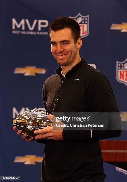 Quarterback Joe Flacco of the Baltimore Ravens poses with the MVP trophy during the Super Bowl XLVII Team Winning Coach and MVP Press Conference at...