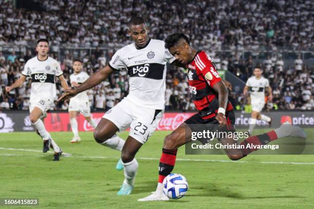 Bruno Henrique of Flamengo challenges for the ball with Jhohan Romaña of Olimpia during a Copa CONMEBOL Libertadores 2023 round of sixteen second leg...