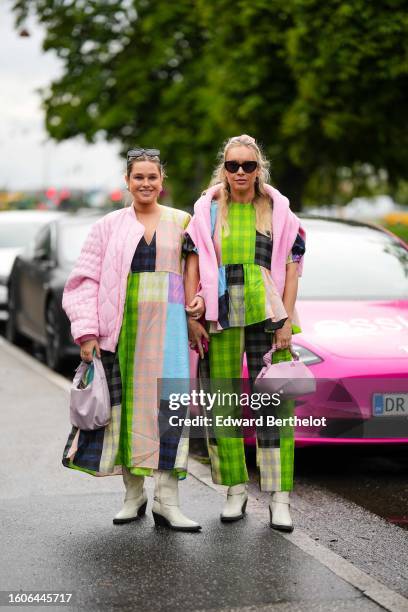 Guest wears black sunglasses, gold earrings, a black and navy blue / green / blue / pink / pale orange checkered print pattern embroidered yoke...