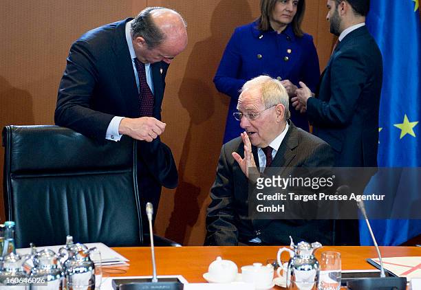 German Finance Minister Wolfgang Schaeuble talks to the Minister of Economy Luis de Guindos at the Chancellery on February 4, 2013 in Berlin,...