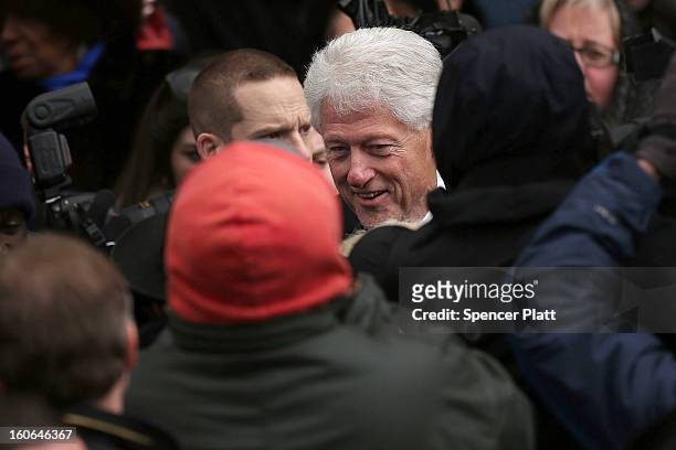 Large crowd gathers around former U.S. President Bill Clinton following the funeral services for former New York Mayor Ed Koch at Manhattan's Temple...
