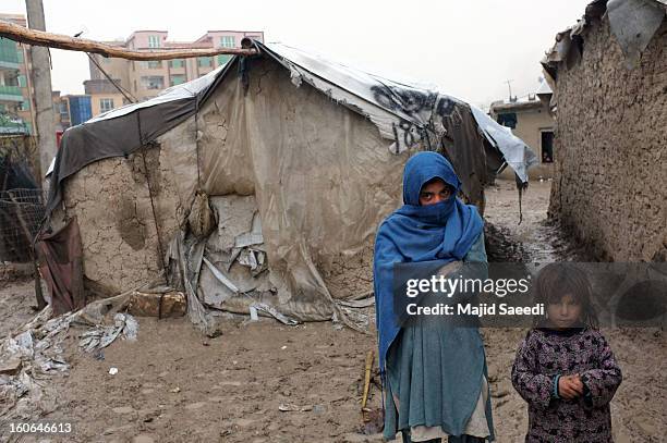 Internally displaced Afghan children wait for aid from the Danish Refugee Council at Chamand babrak Camp, on February 3, 2013 in Kabul, Afghanistan....