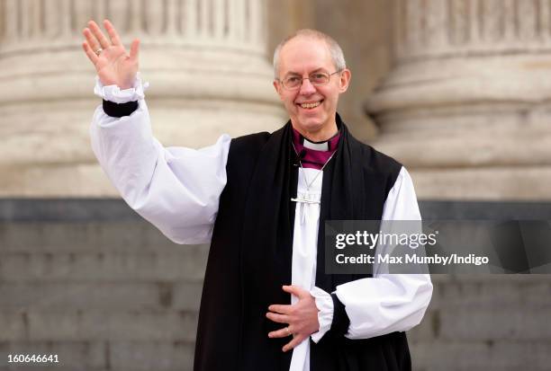 The Most Reverend Justin Welby, Archbishop of Canterbury waves as he stands on the steps of St Paul's Cathedral after attending a service confirming...