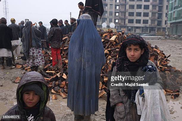 Internally displaced Afghans wait to receive aid donations at Chamand babrak Camp, on February 3, 2013 in Kabul, Afghanistan. According to the UN...