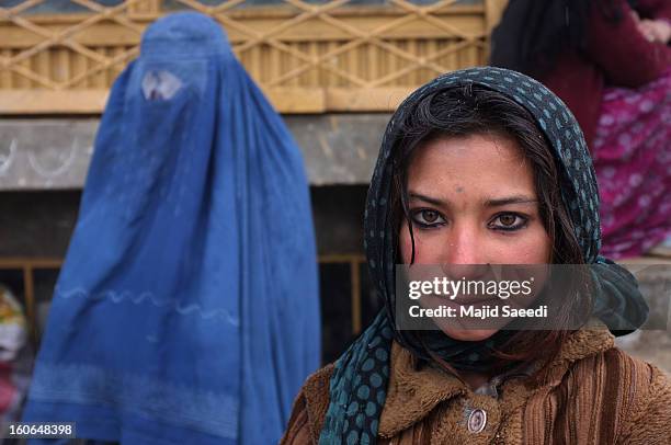 Internally displaced Afghans wait to receive aid donations from the Danish Refugee Council at Chamand babrak Camp, on February 3, 2013 in Kabul,...