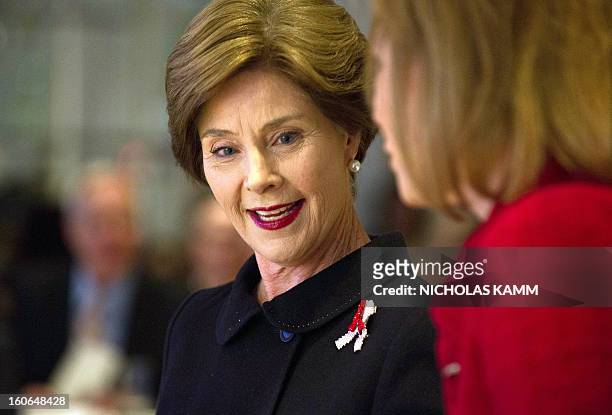 Former US first lady Laura Bush speaks with the founder and CEO of the Susan G. Komen for the Cure organization Nancy Brinker after addressing the...