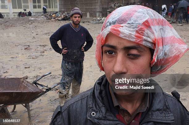 Internally displaced Afghans wait to receive aid donations from the Danish Refugee Council at Chamand babrak Camp, on February 3, 2013 in Kabul,...