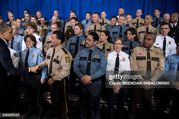 President Barack Obama greets local law enforcement after speaking about gun violence at the Minneapolis Police Department's special operations...