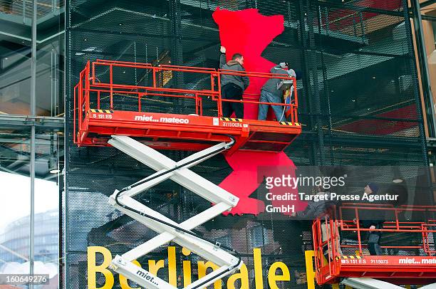 Workers assemble a signboard at the Berlinale Palast for the 63rd Berlinale International Film Festival on February 4, 2013 in Berlin, Germany. The...
