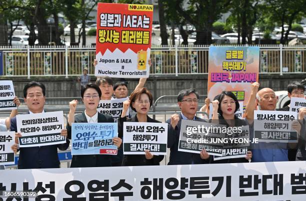 South Korean opposition lawmakers and activists take part in a rally to protest against the Japanese government's plan to release Fukushima...