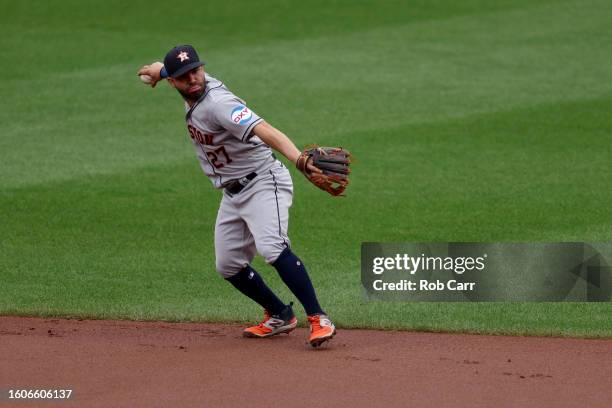 Throwing Tp First Base Jose Altuve of the Houston Astros throws to first base against the ...