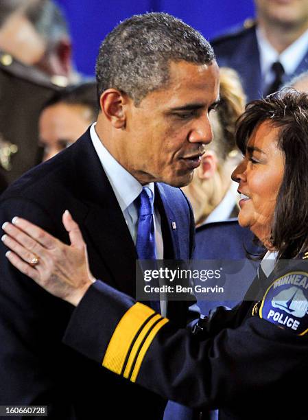 President Barack Obama greets Minneapolis Police Chief Janee Harteau, who introduced the President, after speaking before a group of local leaders...