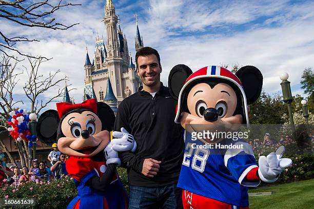 In this handout photo provided by Disney Parks, Super Bowl XLVII MVP Joe Flacco poses with Mickey and Minnie Mouse at the Magic Kingdom at Walt...