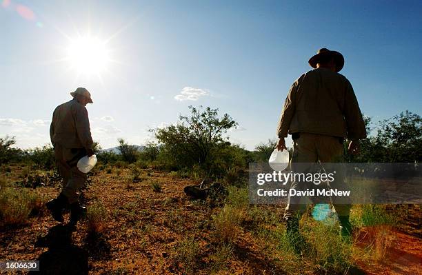 Border Patrol BORSTAR search and rescue agents Abel Melendez, left, and David Howard follow the tracks of someone they fear could be in trouble in...