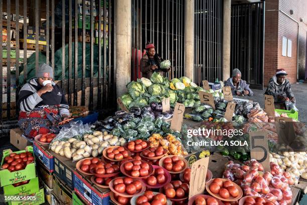 Vendors wait for customers at a fruit stall at the Bara taxi rank market in Diepkloof, Soweto, on August 13, 2023.