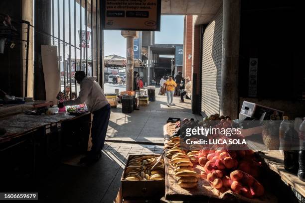 Vendor arranges goods at her stall at the Bara taxi rank market in Diepkloof, Soweto, on August 13, 2023.