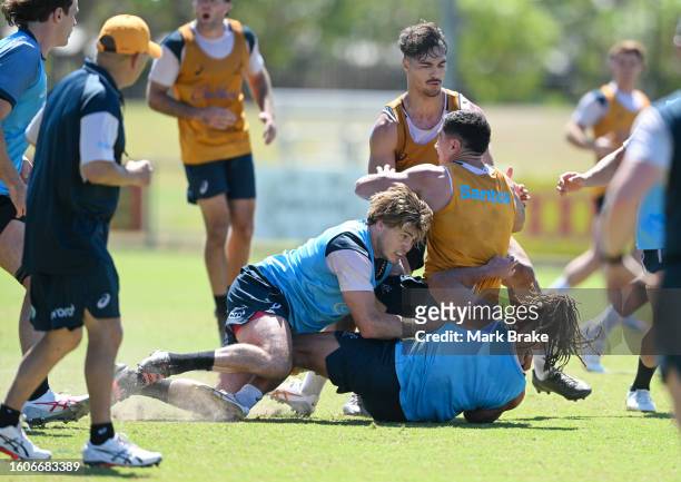 Nic White of the Wallabies tackled by James O'Connor and Issak Fines-Leleiwasa of the Wallabies during the Australia Wallabies training session at...