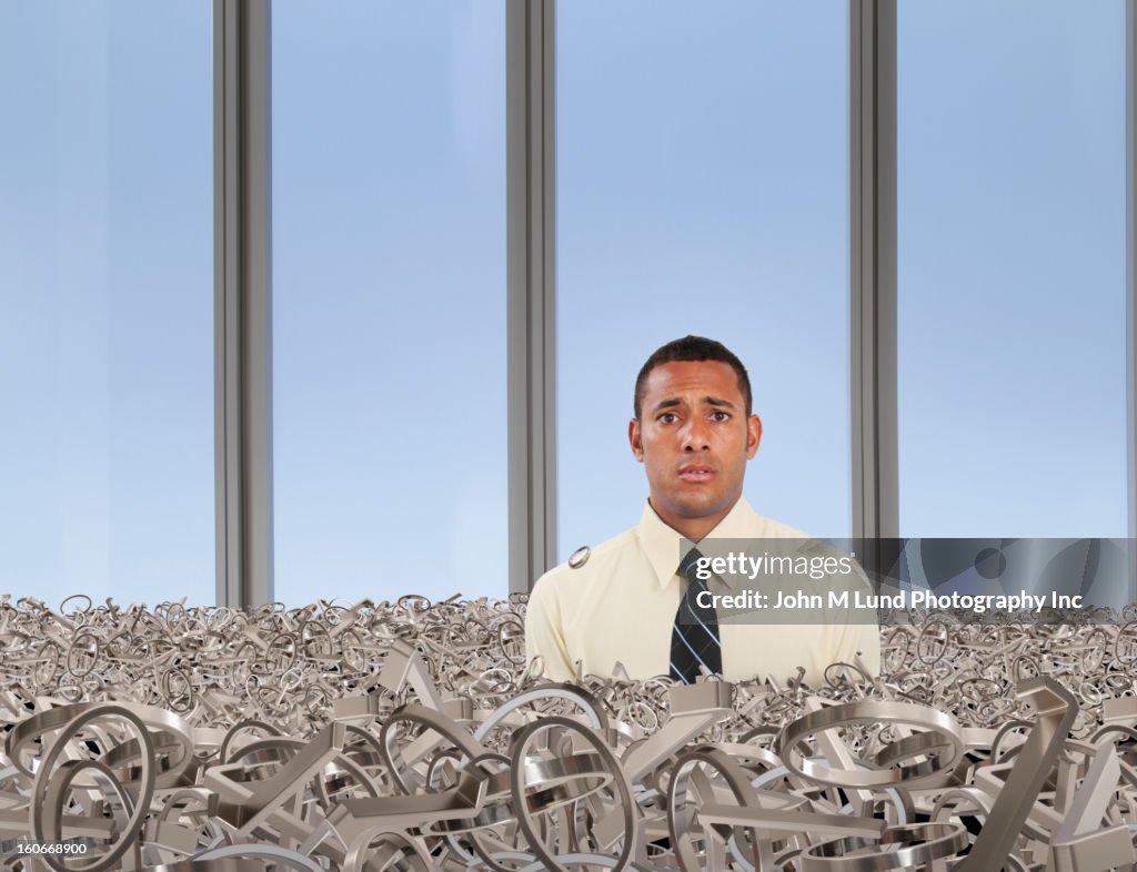 Mixed race businessman covered in metal circles